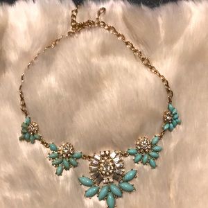 Turquoise colored necklace with rhinestones.